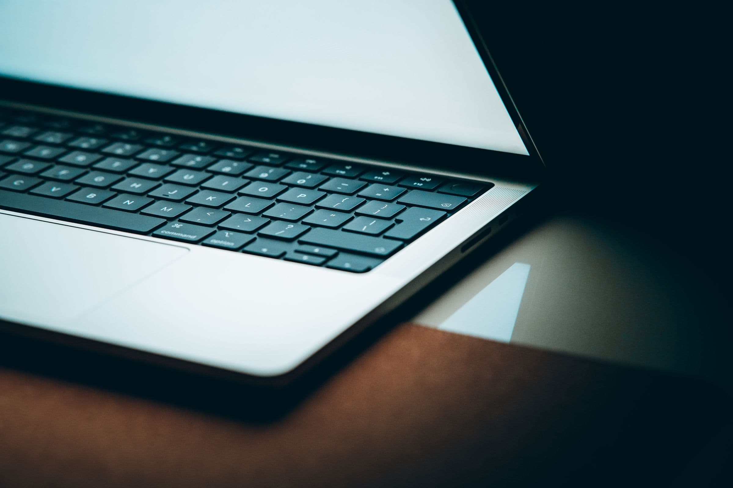 A business-class laptop on a warm desk